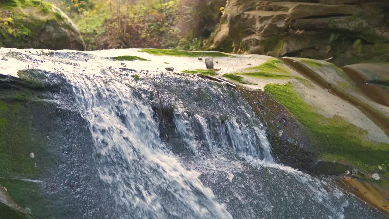 秋天，在岩石之间有快速流动的清澈的水的小山涧。视频素材