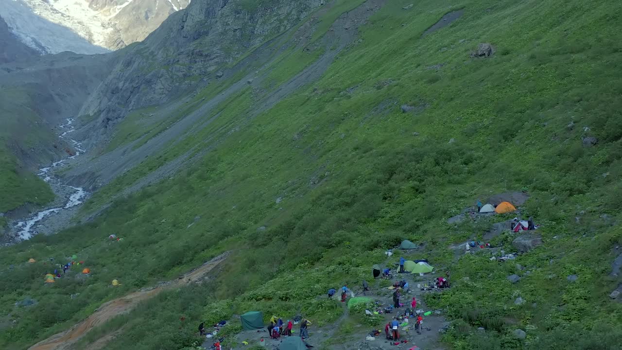 鸟瞰图的一个旅游营地附近的山脚下，河流和冰川。视频素材