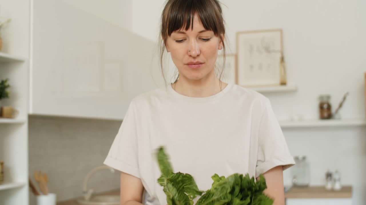 女人在厨房里做蔬菜沙拉视频素材