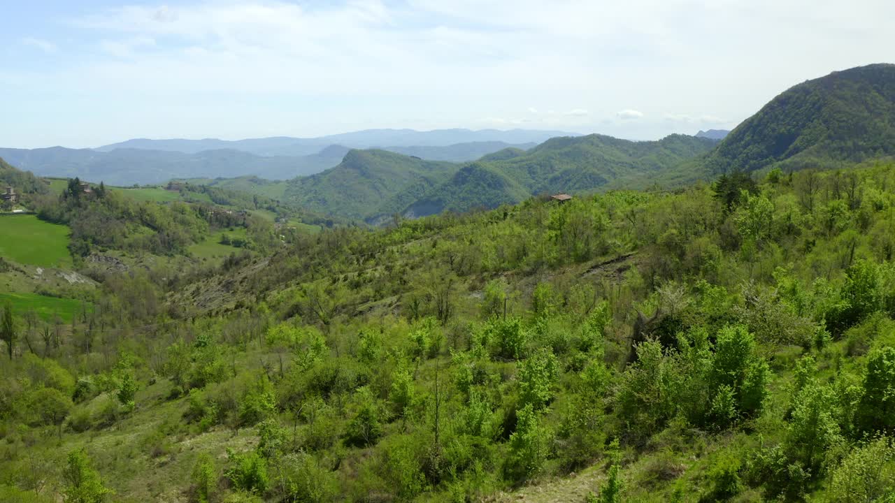 空中美丽的绿色山脉对多云的天空，无人机飞过树木-亚平宁山脉，意大利视频素材