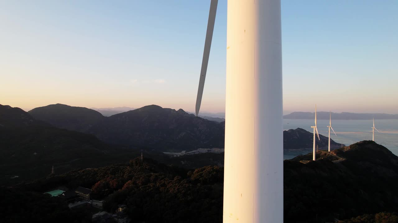 鸟瞰图的风力涡轮机在山上的海边视频素材