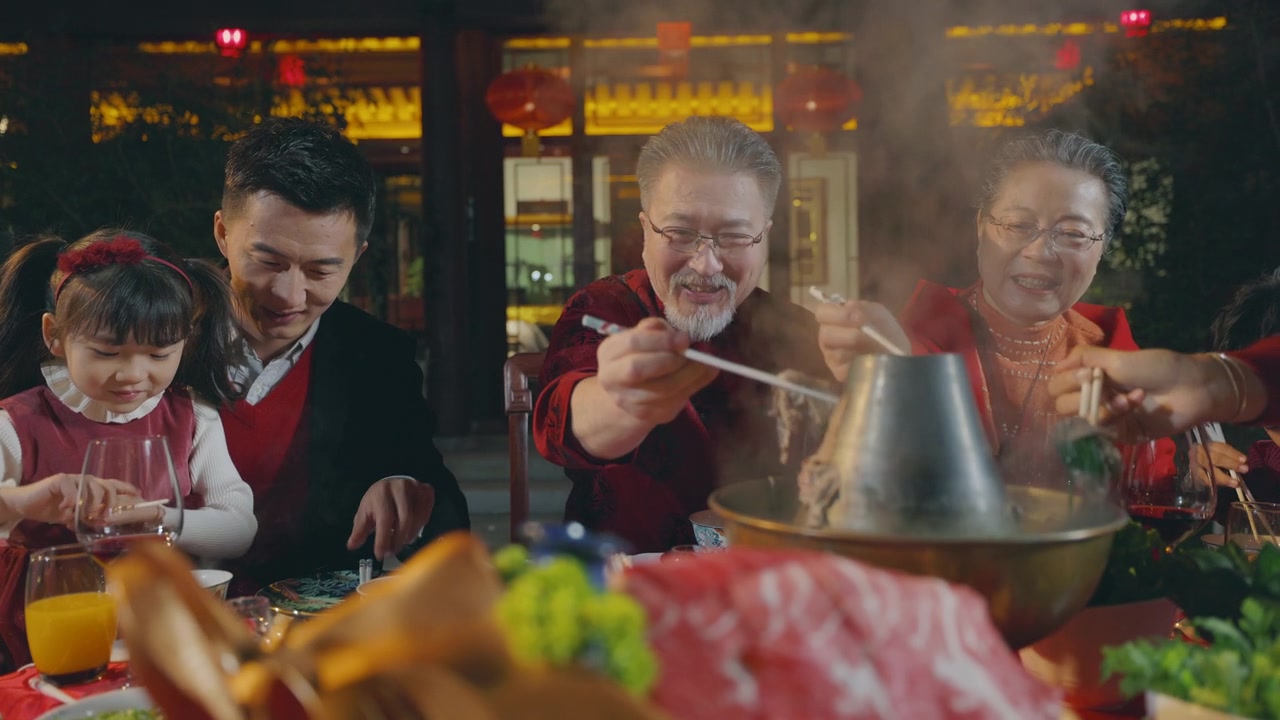 东方家庭在春节期间在中国的院子里吃晚饭视频素材画面2