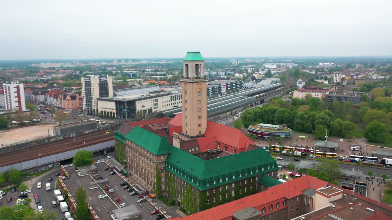 在Rathaus Spandau的高塔上飞行。斯潘道镇市政厅的历史建筑。以火车站为背景的城市。柏林,德国视频素材画面2
