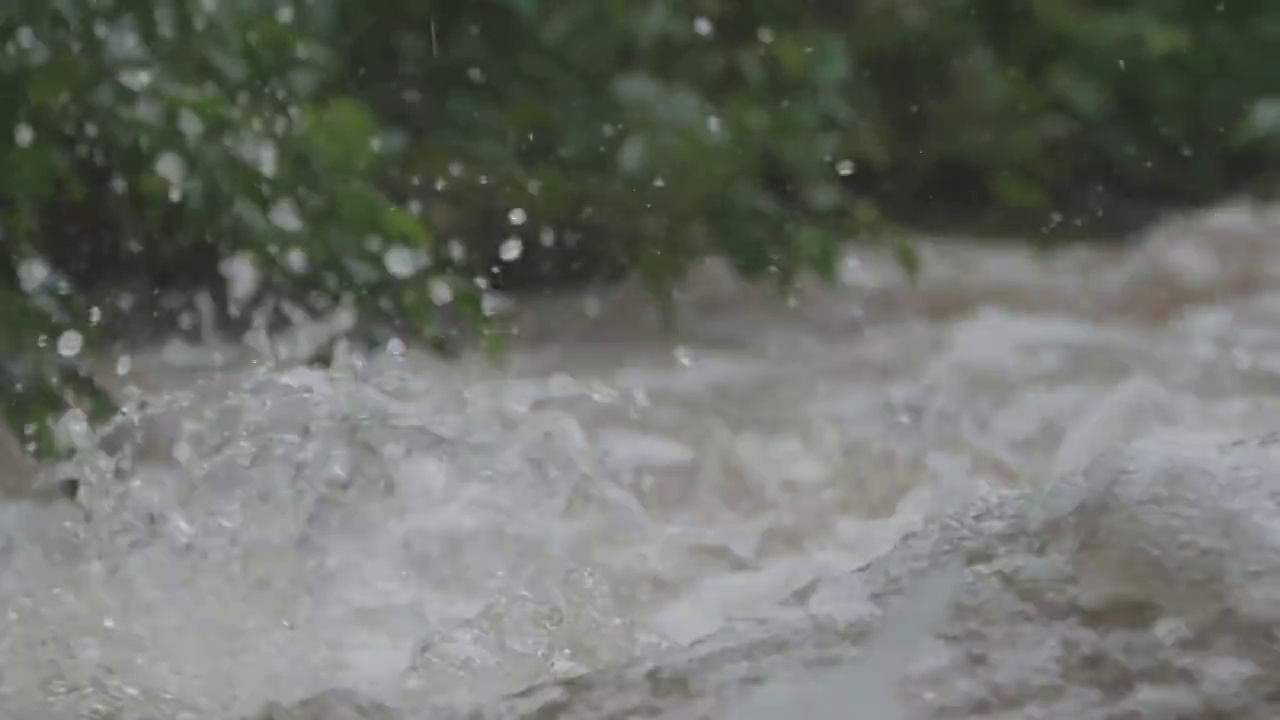 一场倾盆大雨过后，湍急的山河中溅满了泡沫和水花，跳过了岩石视频素材