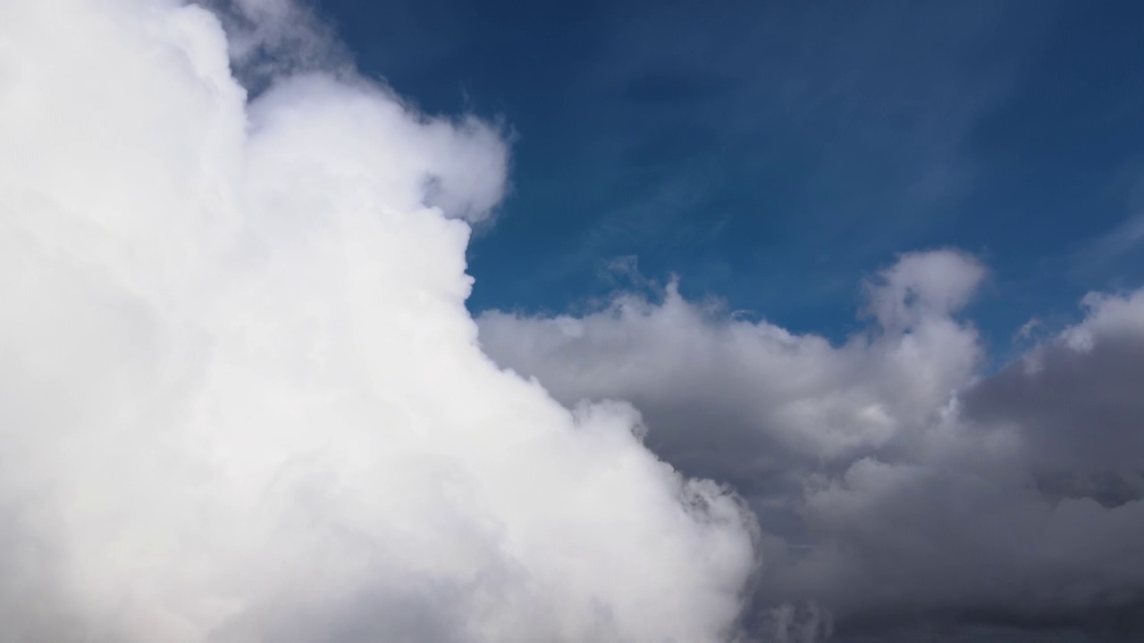 从飞机窗口高空俯瞰，在暴雨前形成的蓬松的积云覆盖着大地视频素材