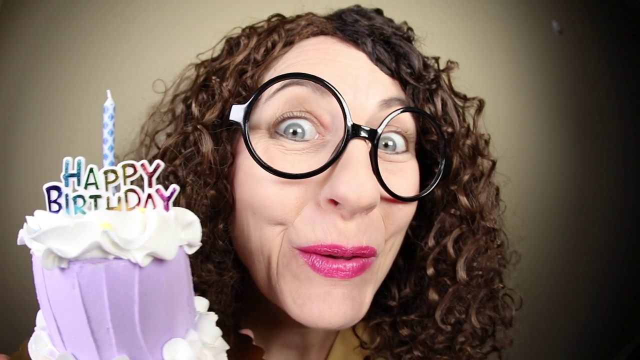 捧着蛋糕唱生日歌的女人视频素材画面2