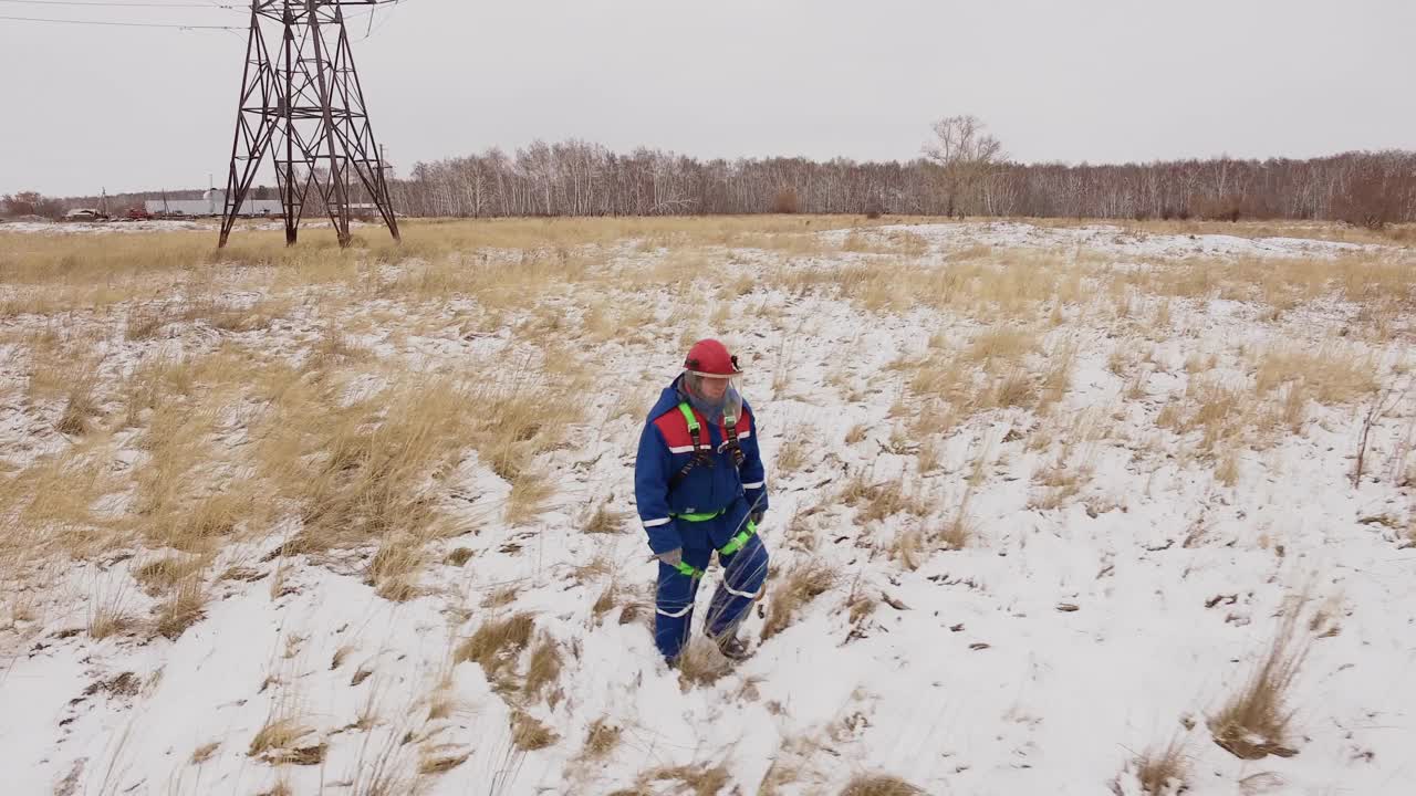 电工走在电站的雪地上视频素材