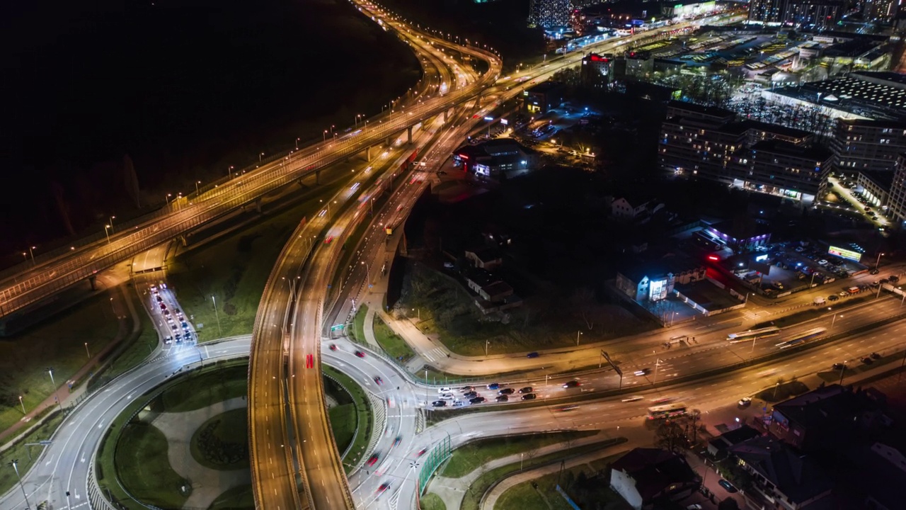 无人机延时汽车交通堵塞环行立交道路夜间，俯视图交叉口公路交叉口夜间。时间推移汽车行驶繁忙的十字路口快速运动视频素材