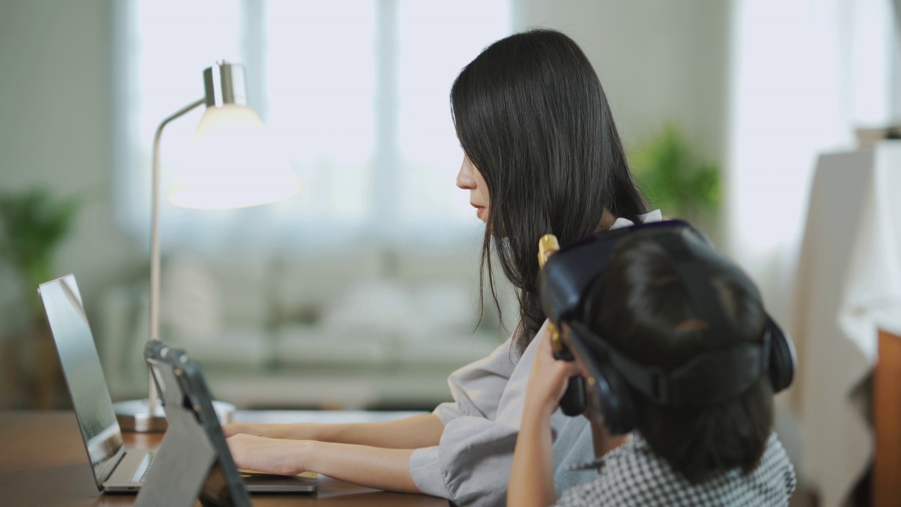 亚裔妈妈上班，亚裔女儿将来会戴眼镜。视频素材画面4