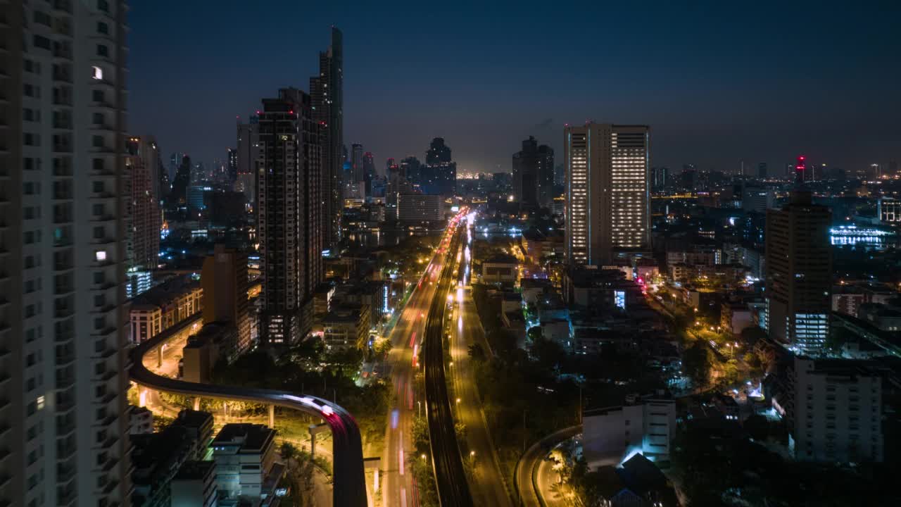 无人机超时间延时拍摄的日出场景，交通车灯在高速公路和地铁空中列车跨越湄南河在曼谷视频素材