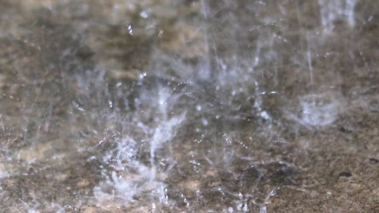 雨点打在这片区域上，发出独特有趣的、闪闪发光的白色火花。视频素材