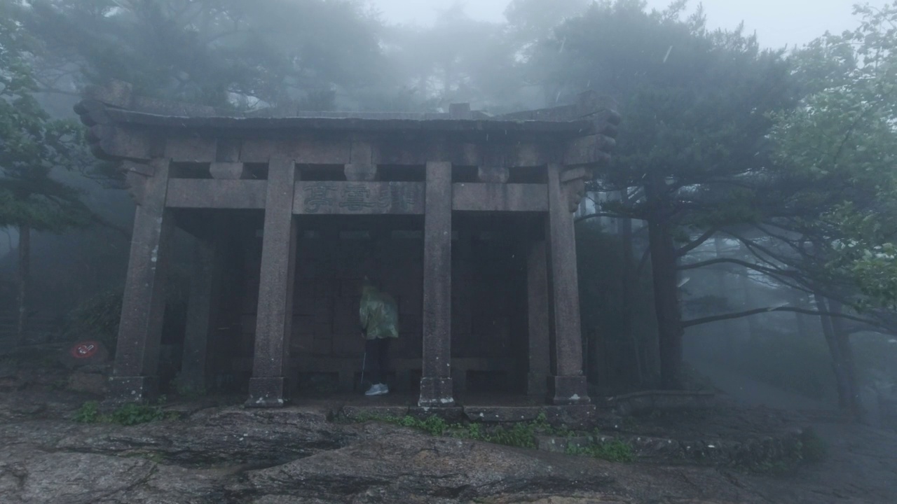 中国安徽黄山，游人在雨中走过亭子视频素材画面3