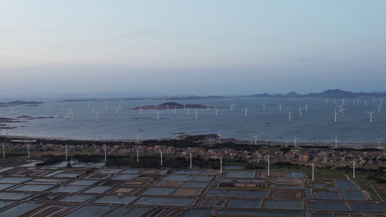 风力涡轮机散落在海滩和大海的鸟瞰图视频素材