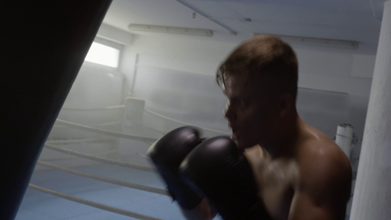 拳击手用拳梨锻炼，训练出拳，手持射击视频素材画面3