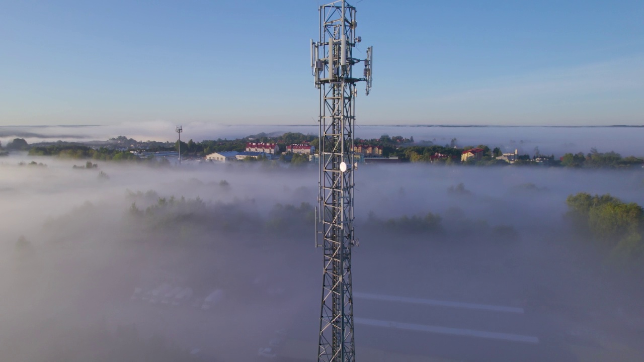 塔式天线电信手机鸟瞰图，蜂窝5g 4g手机无线电发射机。提供高速现代5g交通网络服务。日出时分的雾、云和天空视频素材