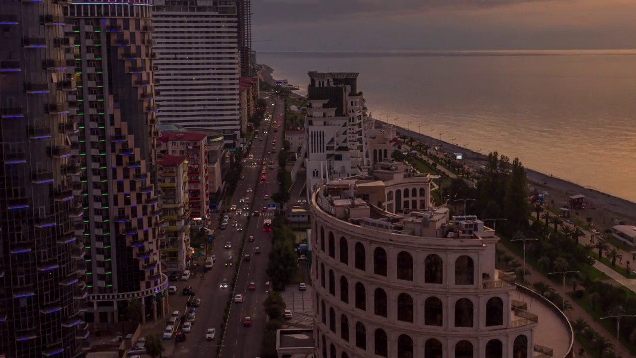 Sunset cityscape of illuminated Batumi – Drone Hyperlapse视频素材