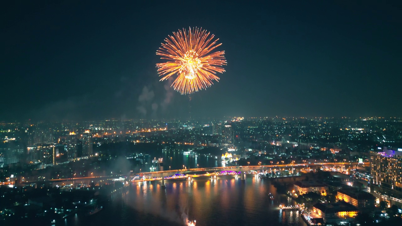 空中无人机视角多色烟花表演在天空之城。除夕。摩天大楼和城市景观庆祝夜晚的灯光视频素材