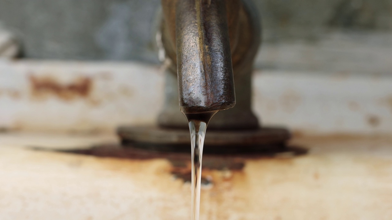 供水问题-旧生锈的水龙头滴落着脏水。供水问题-旧生锈的水龙头滴落着脏水。干旱或水管事故，危机，贫穷视频素材