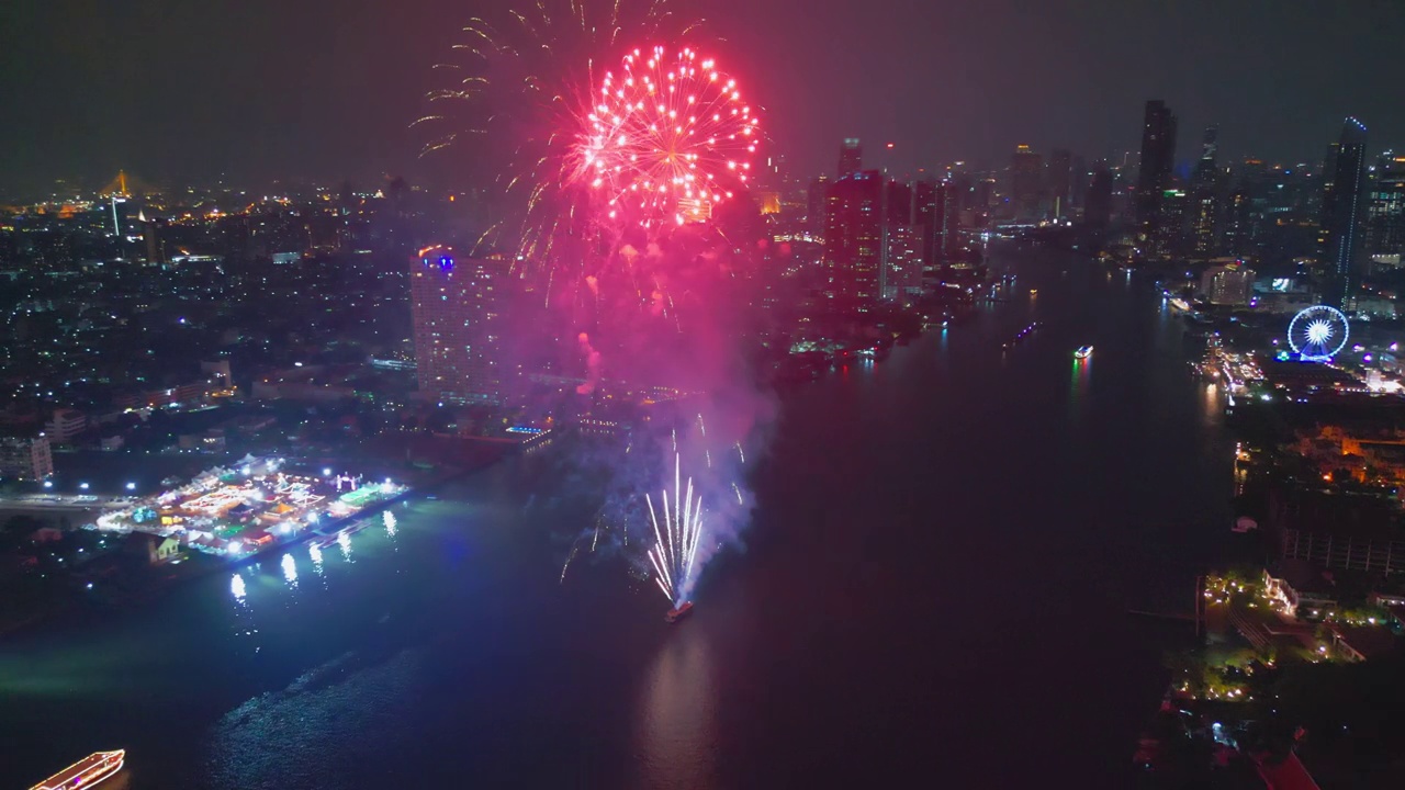 空中无人机视角多色烟花表演在天空之城。除夕。摩天大楼和城市景观庆祝夜晚的灯光视频素材