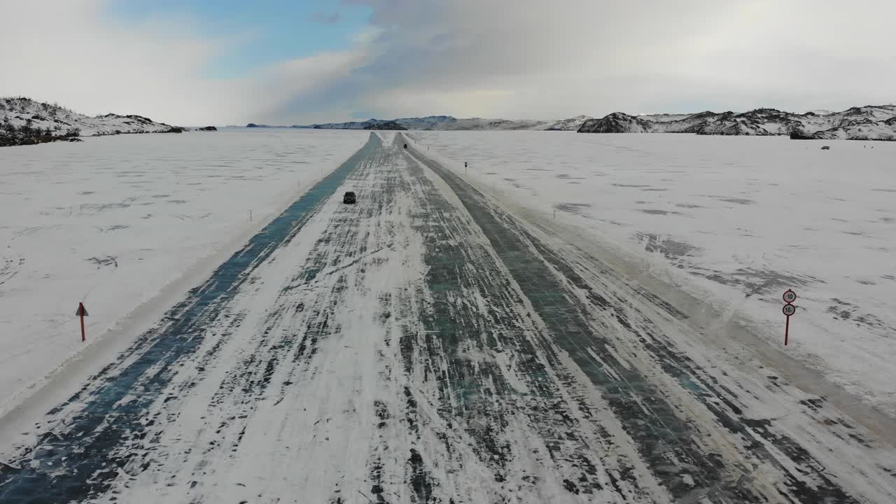 汽车沿着结冰的道路驶向奥尔洪岛。鸟瞰图。视频素材