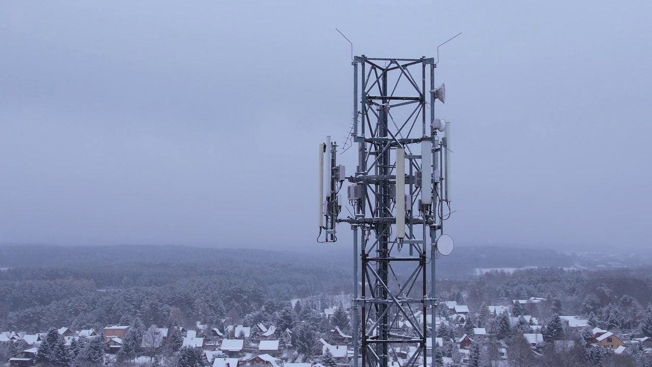塔天线电信手机鸟瞰图，蜂窝5g 4g手机无线电发射机。提供高速现代5g流量网络服务。雪自然森林冬天。视频素材