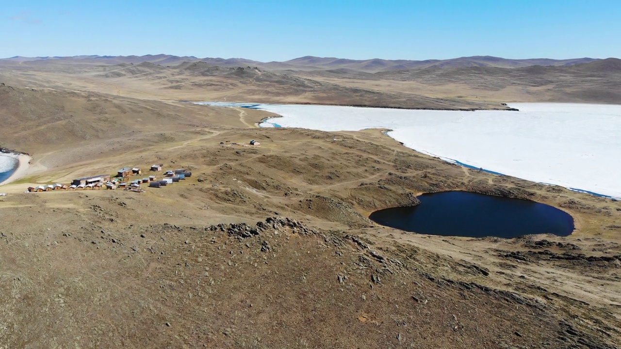 在一个阳光明媚的春日，奥尔洪岛心形湖Nuku-Nur附近的旅游房屋和露营地的鸟瞰图。视频素材