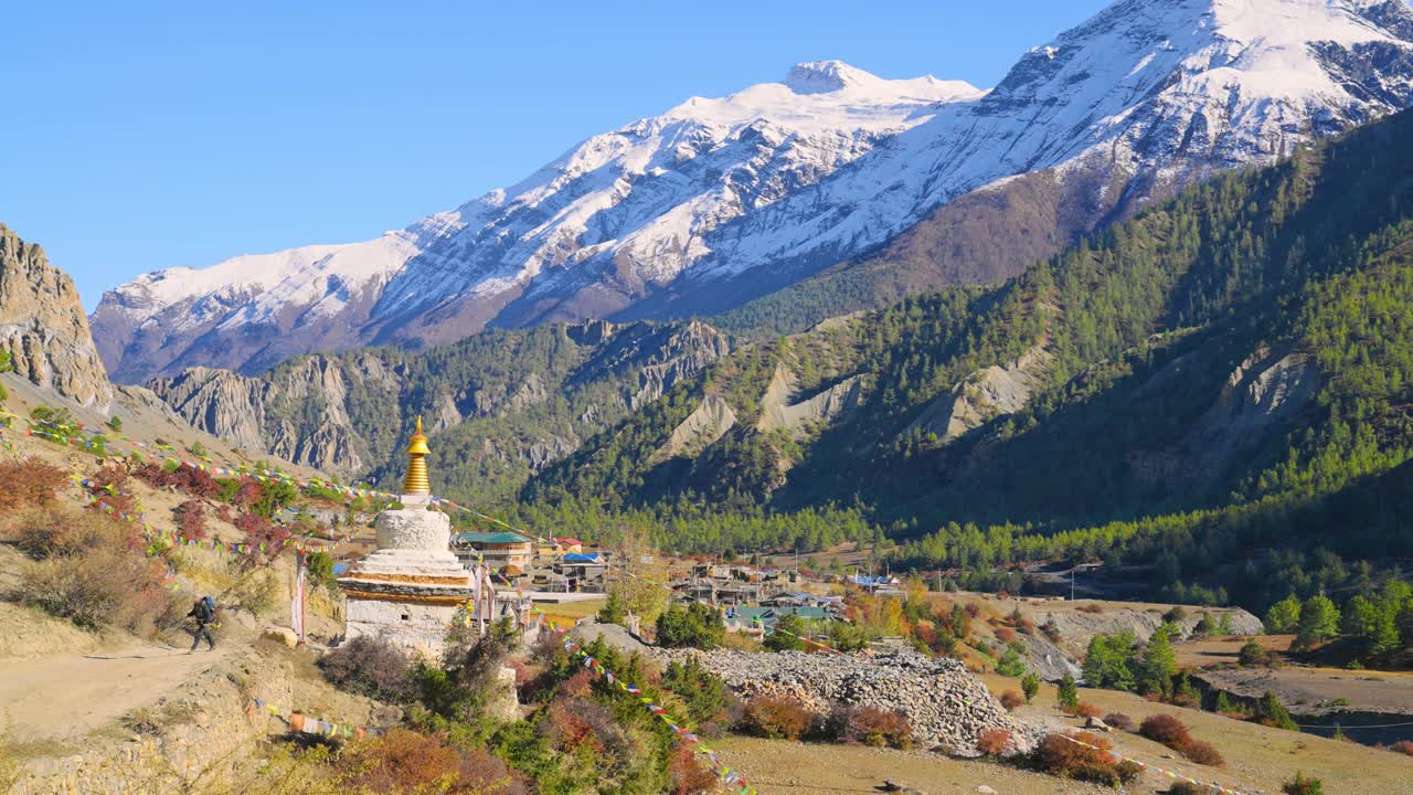 宗教佛教佛塔与经幡沿安纳普尔纳电路小径与山谷和全景山脉的视野，尼泊尔视频素材