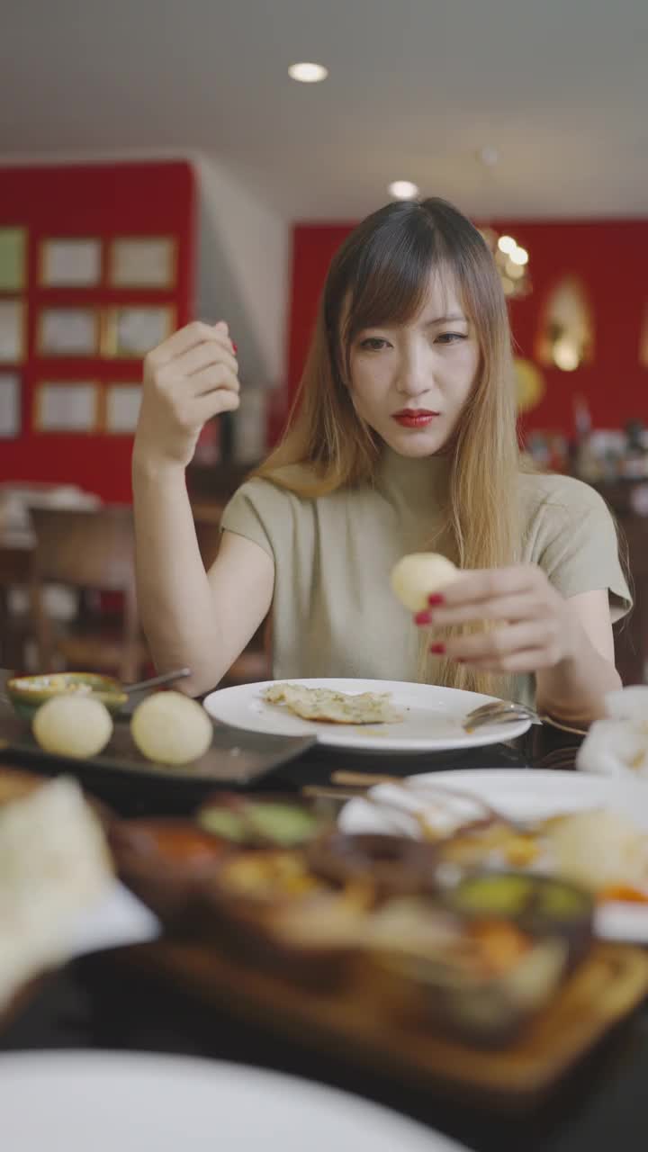 年轻的亚洲妇女愉快地拿起酸辣酱为帕尼普里视频素材