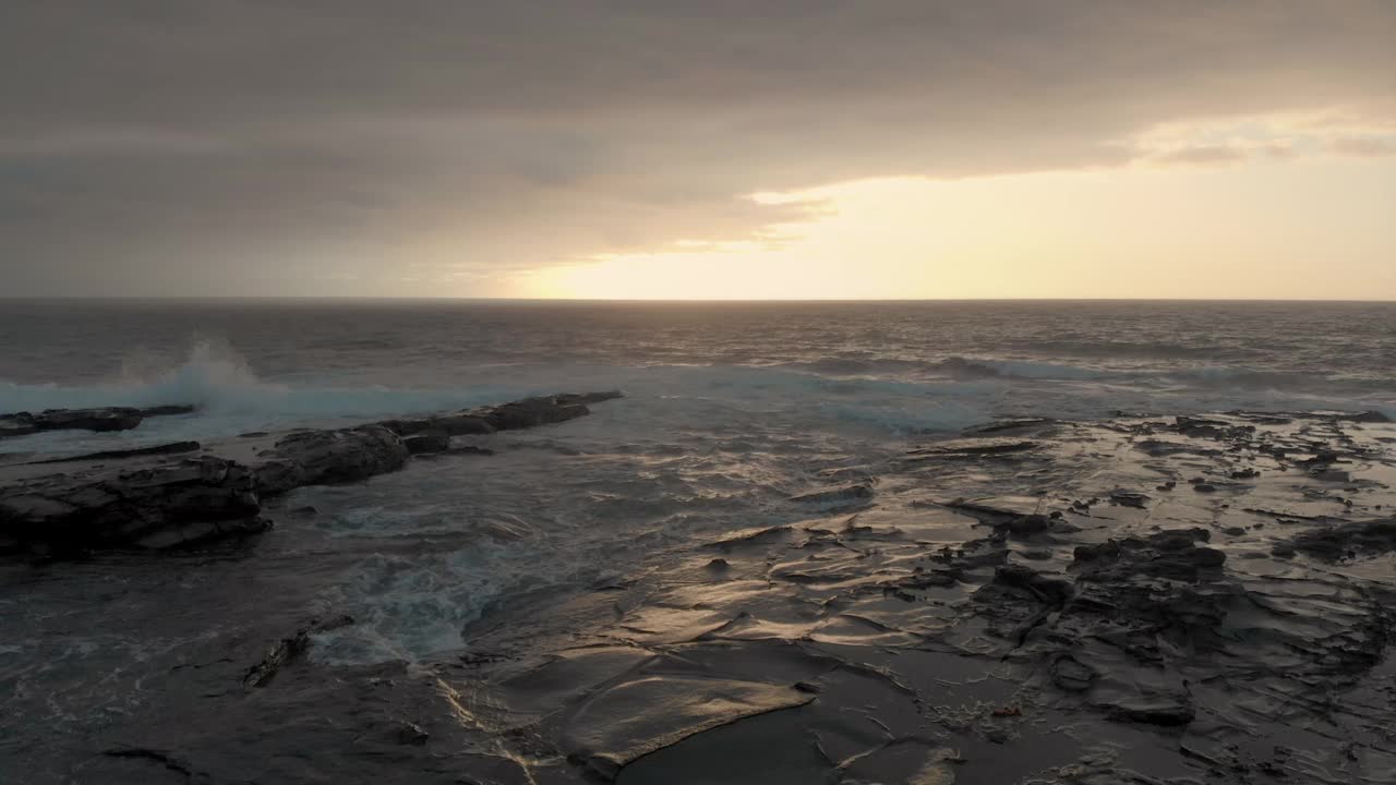 黄昏时分，澳大利亚的冲浪海岸，海浪拍打着岩石海岸视频素材