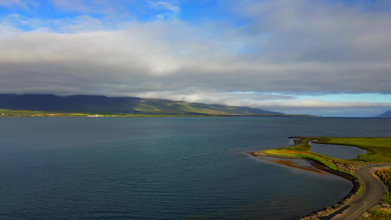 冰岛鲸鱼峡湾(Hvalfjorour)的景观景观，郁郁葱葱的植被，多云的天空视频素材