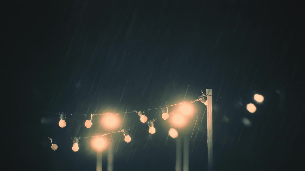 透过窗户看到后院的暴风雨景象，有一串灯视频素材