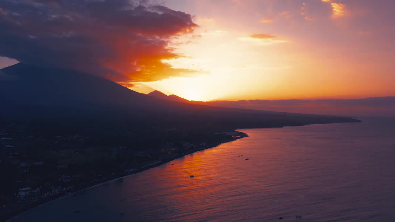 在jeemeluk海滩上的阿米德，可以看到古农阿贡火山的惊人日落。空中无人机观看4K。视频素材