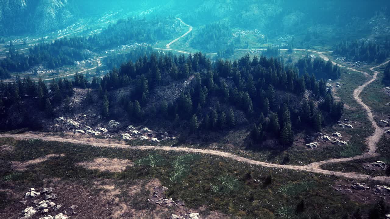 一条蜿蜒的土路穿过雄伟的山峦视频素材