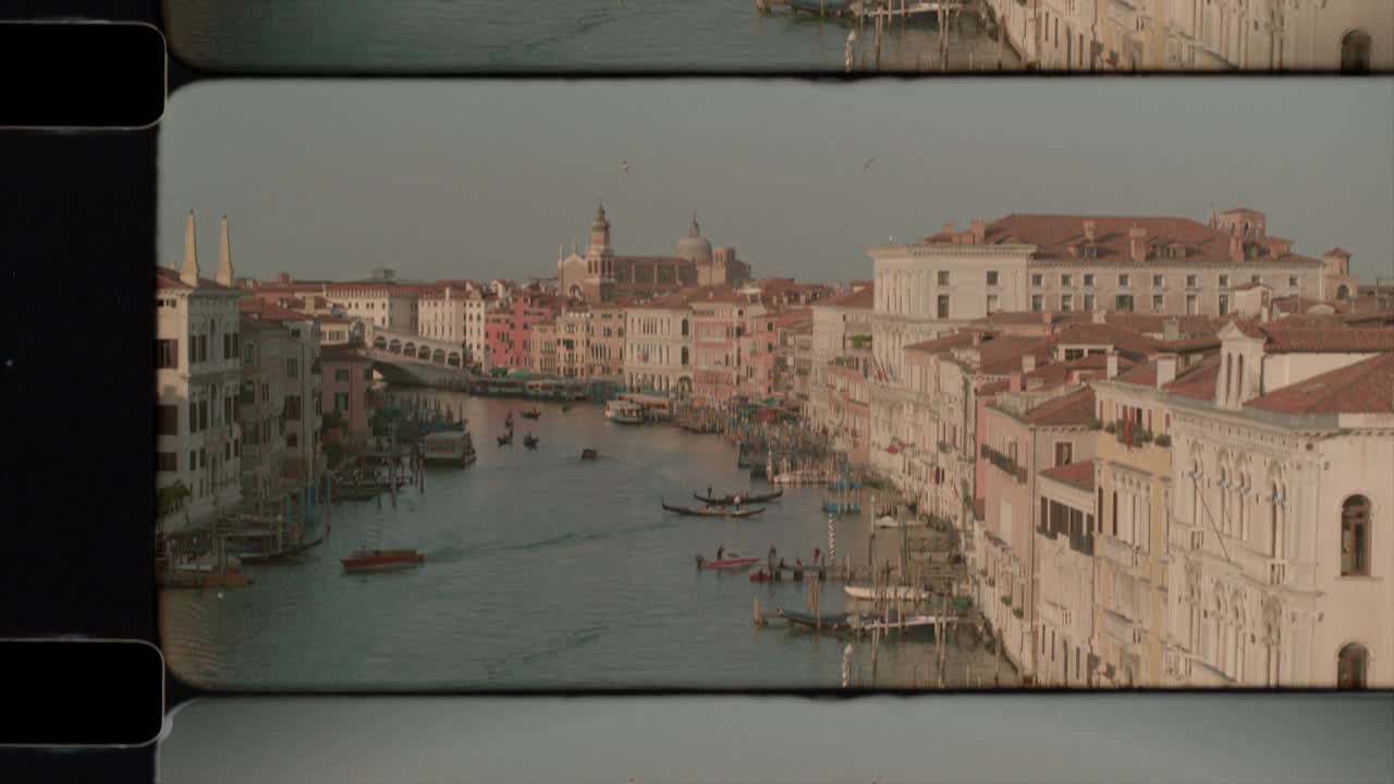 阳光下的意大利威尼斯大运河上的里亚托桥和圣马可钟楼鸟瞰图。4 k视频下载