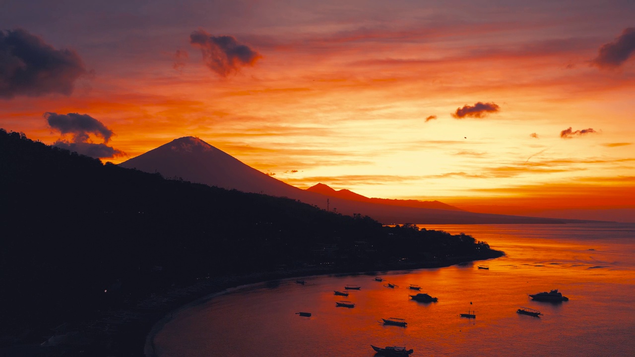 在jeemeluk海滩上的阿米德，可以看到古农阿贡火山的惊人日落。空中无人机观看4K。视频素材