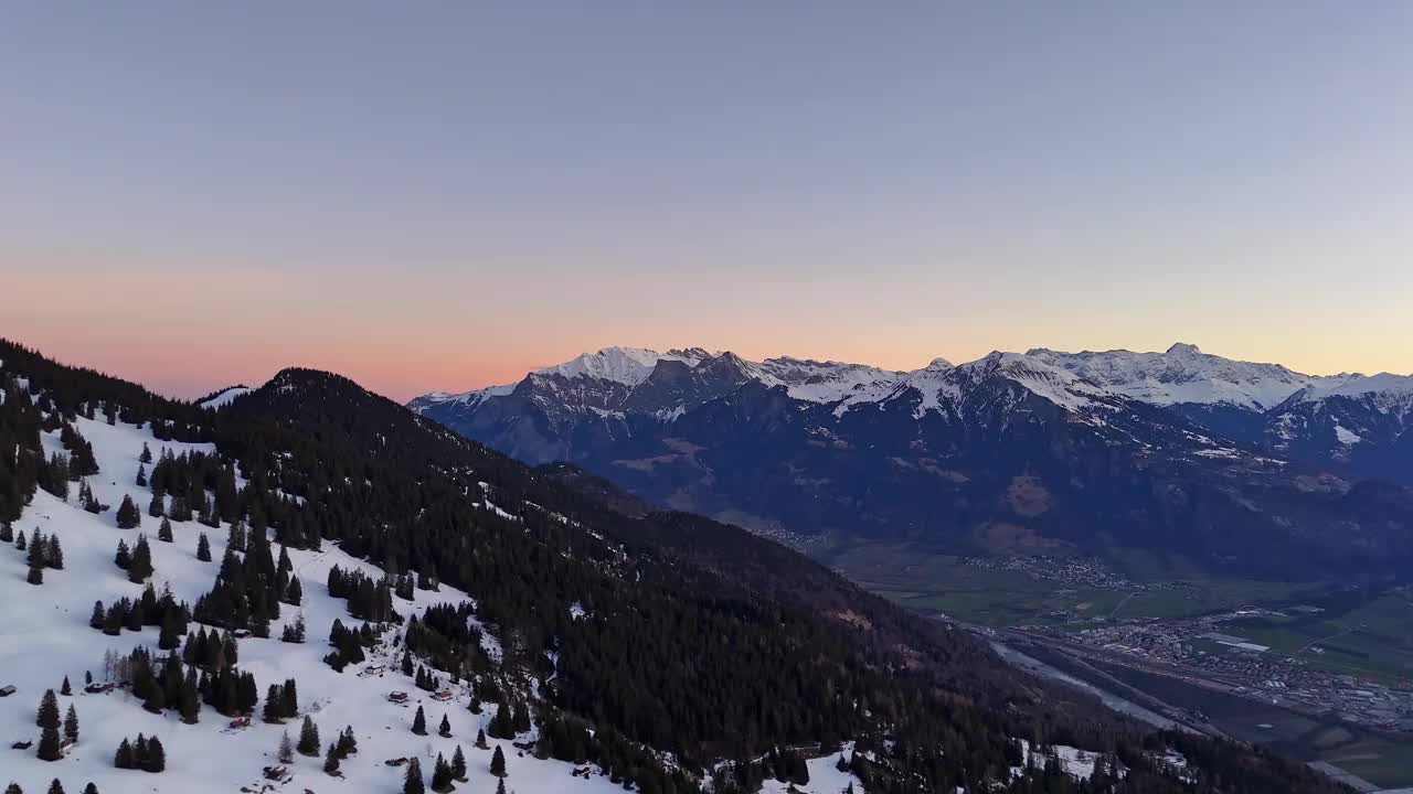 瑞士昂特瓦兹的日落景色，高山上的高山辉光，山谷中的松树，空中拍摄视频素材