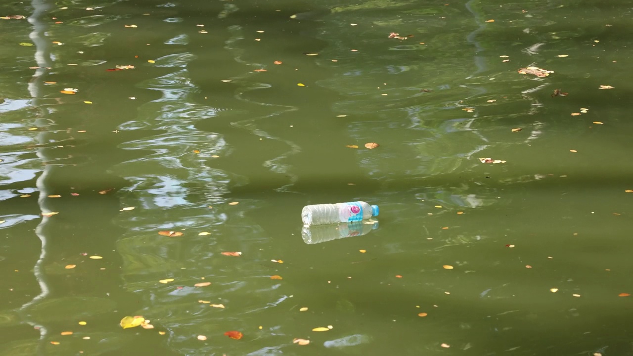 漂浮在被污染的河流上的罐头视频素材