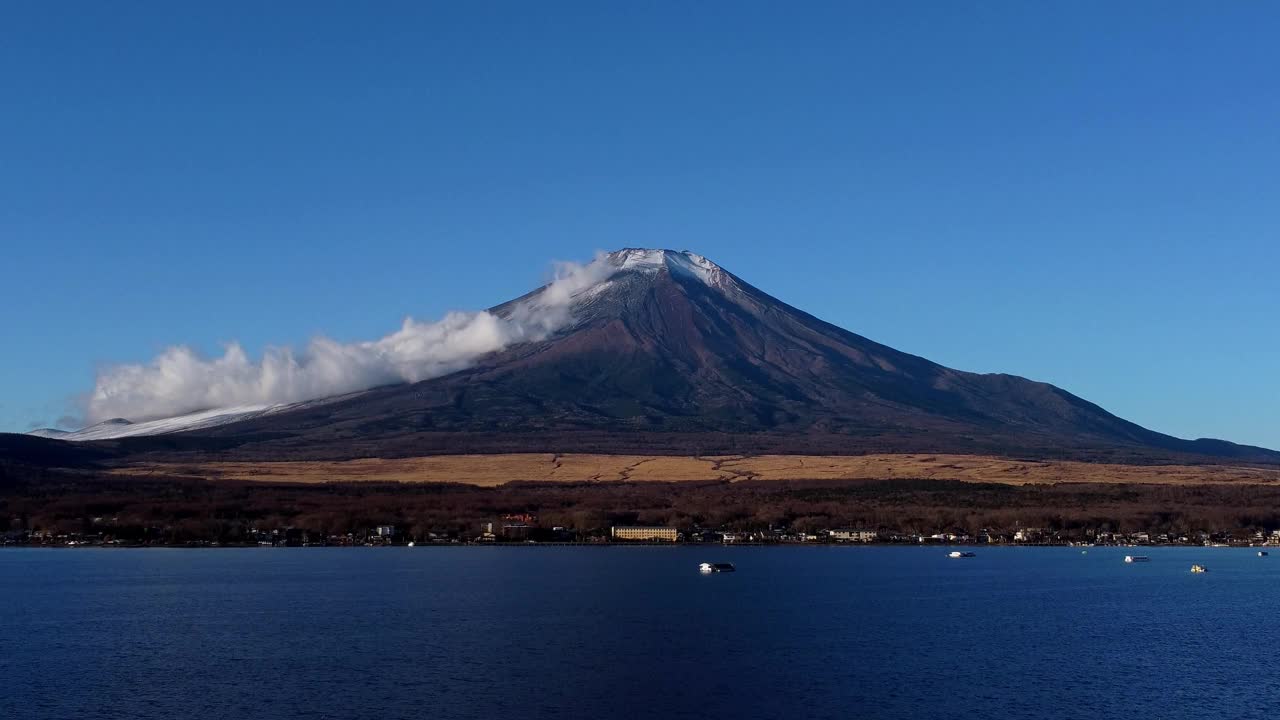 雄伟的富士山，白雪皑皑的山顶，清澈的蓝天和湖泊在前景，宁静的自然景象视频素材