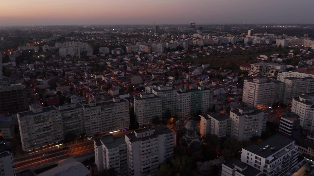 黄昏降临在布加勒斯特的天际线上，温暖的灯光和城市的辉光，鸟瞰图视频素材