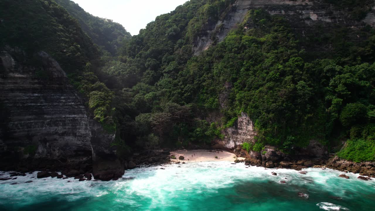 印度尼西亚巴厘岛努沙佩尼达的岩石海岸上幽静的悬崖边海滩。无人机镜头，慢镜头视频素材