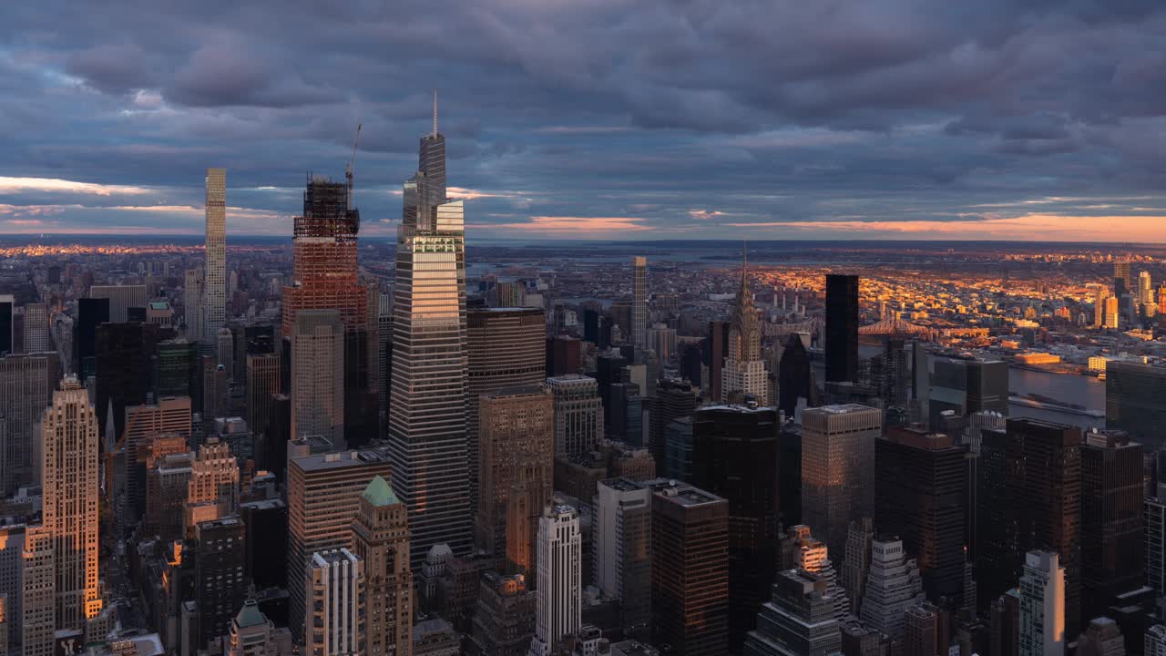 纽约曼哈顿中城超高层摩天大楼的延时鸟瞰图，被温暖的夕阳照亮视频下载