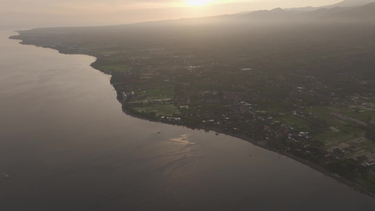 鸟瞰宁静的日出在村庄和大海，洛维纳，巴厘岛，印度尼西亚。视频素材