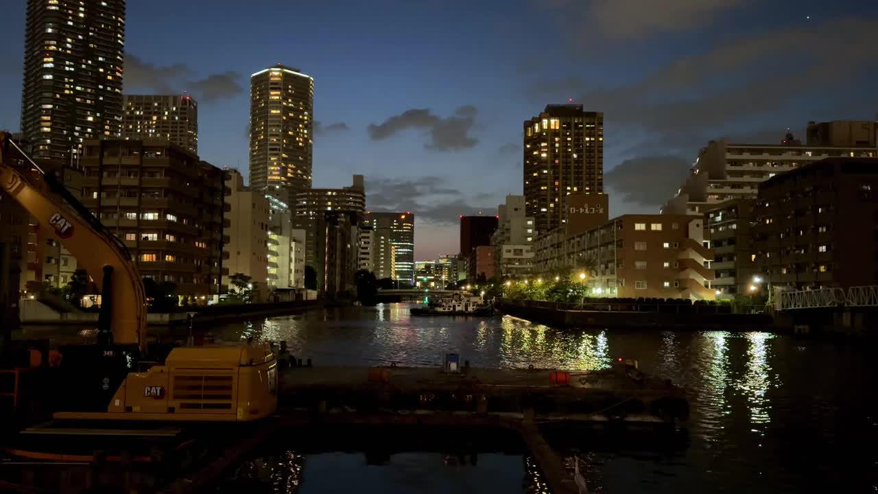 城市的天际线和河流，以及黄昏时分灯火通明的建筑物视频素材