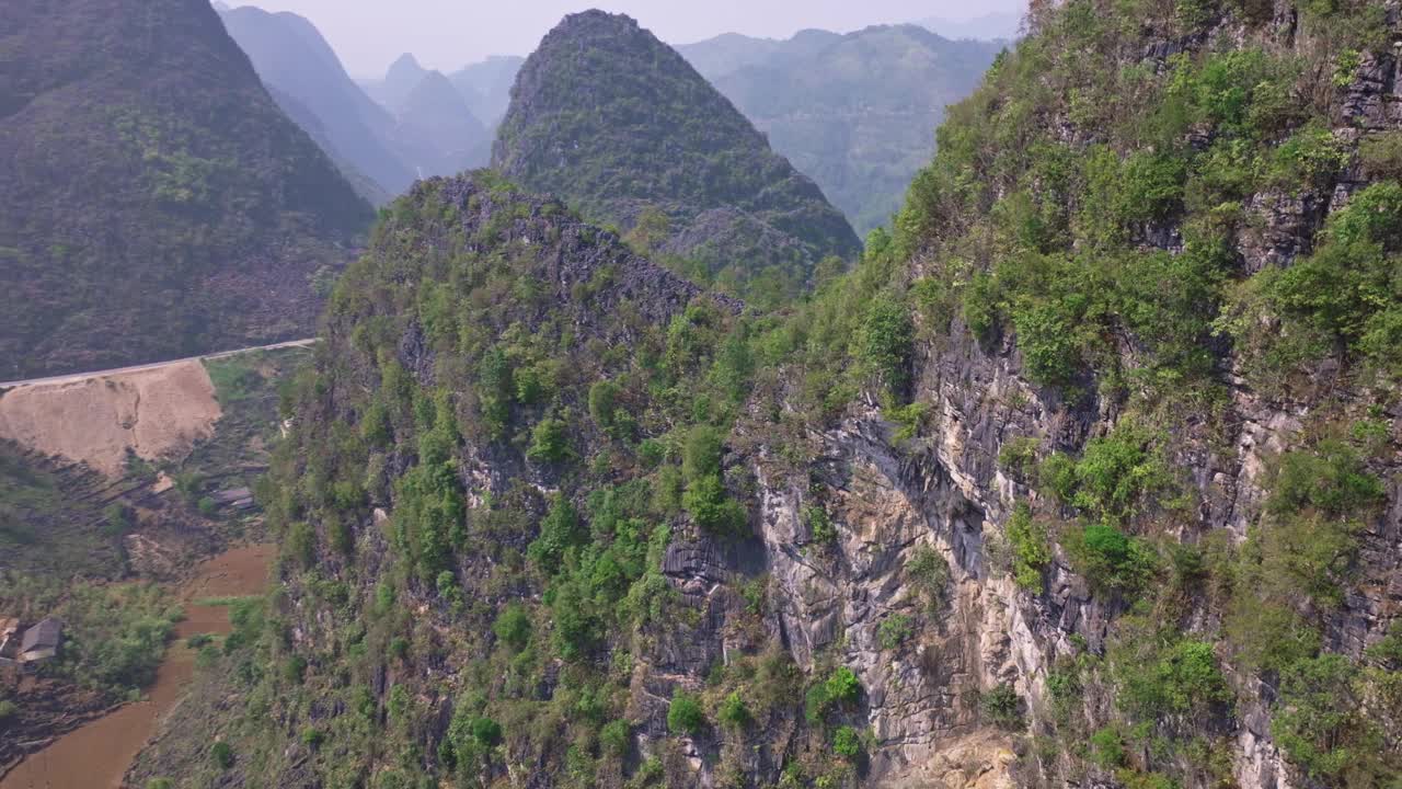 令人惊叹的无人机拍摄的河江崎岖的山脉。摄像机聚焦在山上一个巨大而有趣的洞上，突出了该地区的自然美景和地质奇观。视频素材