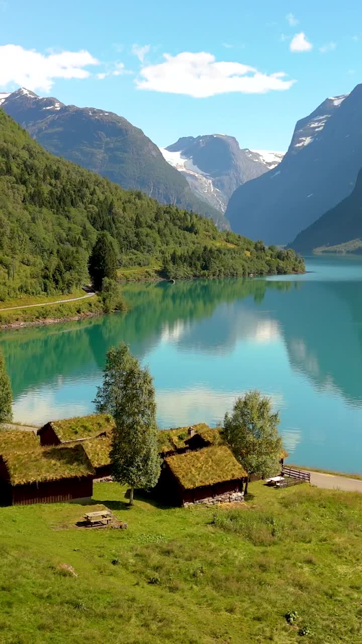 体验美丽的小屋在令人惊叹的山间湖景，挪威洛瓦内特视频素材