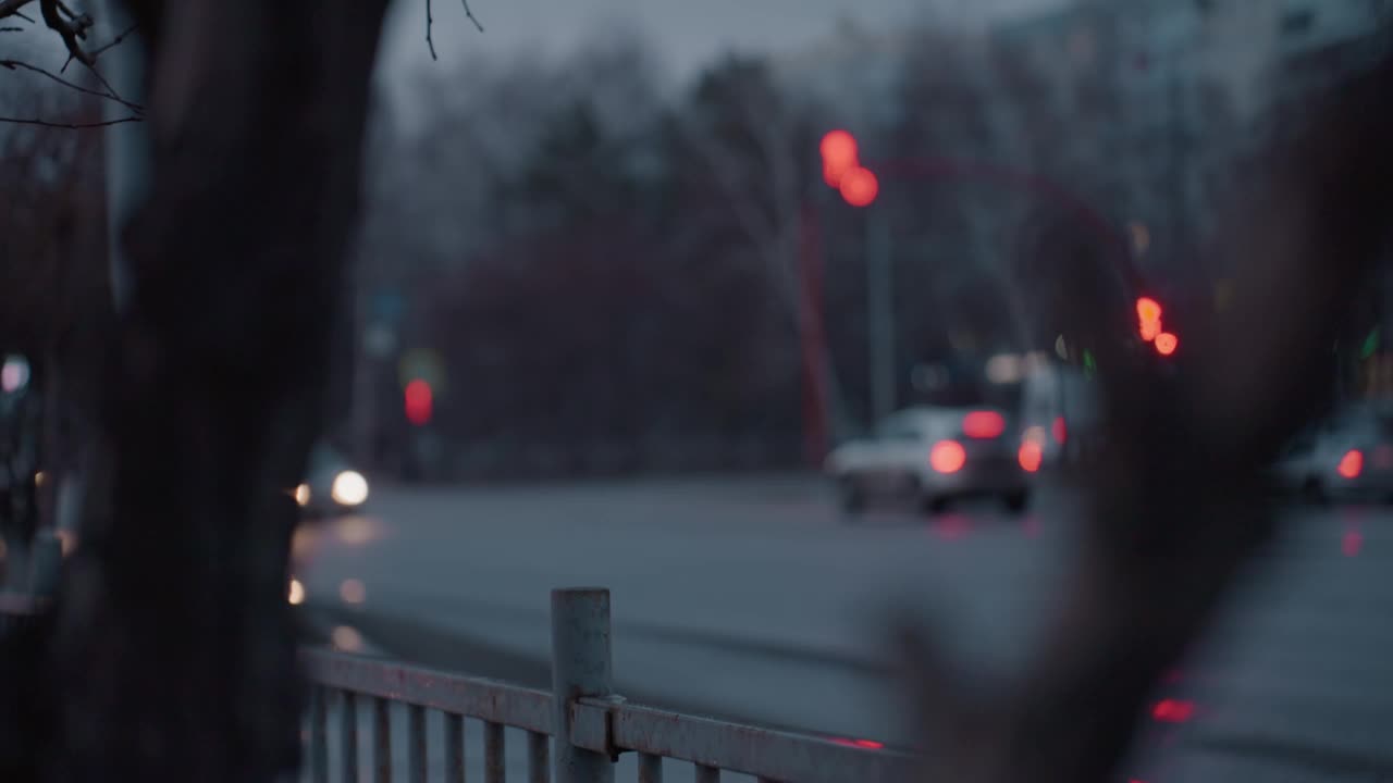 城市街道的模糊视图与汽车前灯和交通灯在夜间视频素材