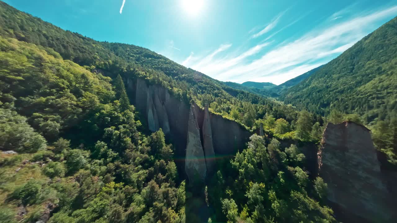 在一个阳光明媚的日子里，塞贡萨诺引人注目的地球金字塔以郁郁葱葱的绿色山脉为背景视频素材