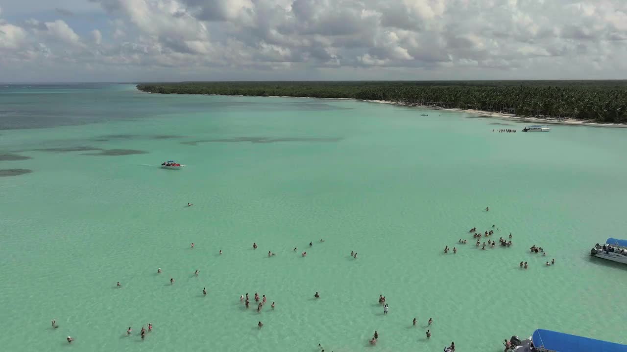 游客们在清澈的绿色海洋中央的天然水池中沐浴视频素材