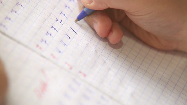 写作的第一步:小学生在方格笔记本上写数字视频素材画面4