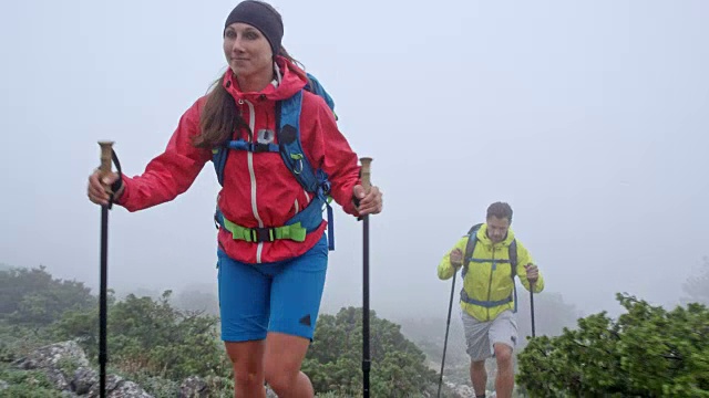 女人和男人在浓雾中爬山视频素材